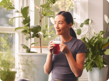 A woman holding a drink in her hand.