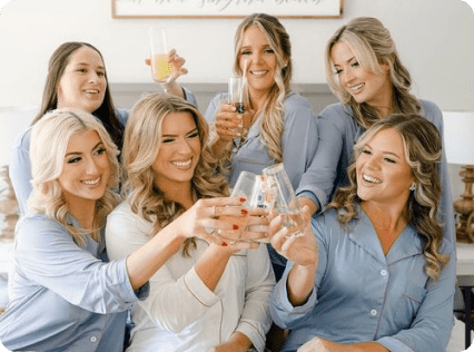 A group of women holding wine glasses in their hands.