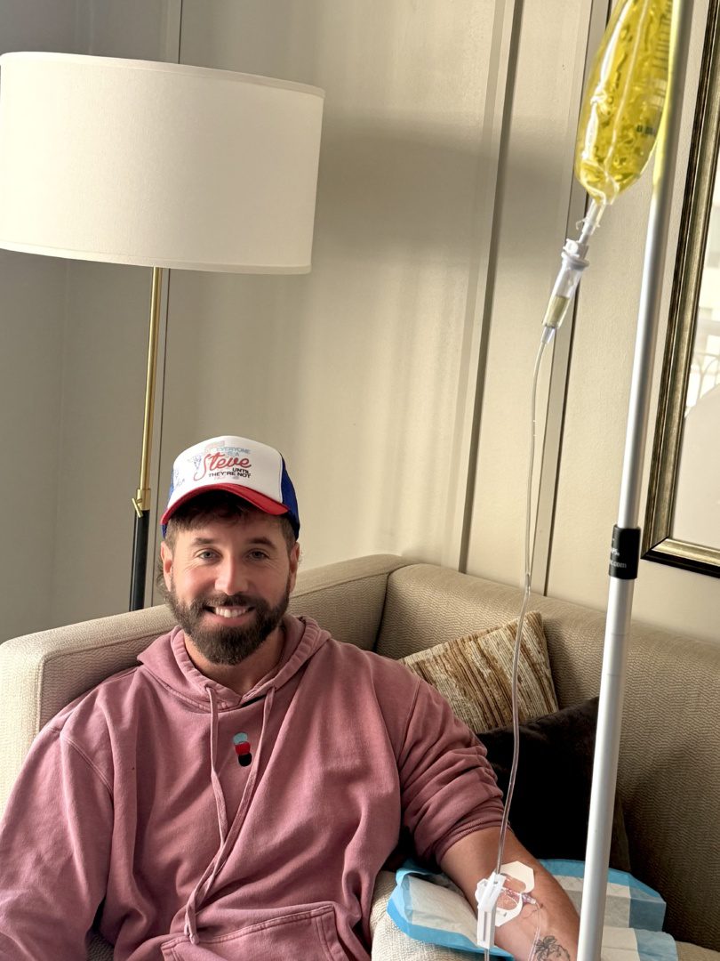 IV Bird client resting on his couch at home during a mobile IV in Austin