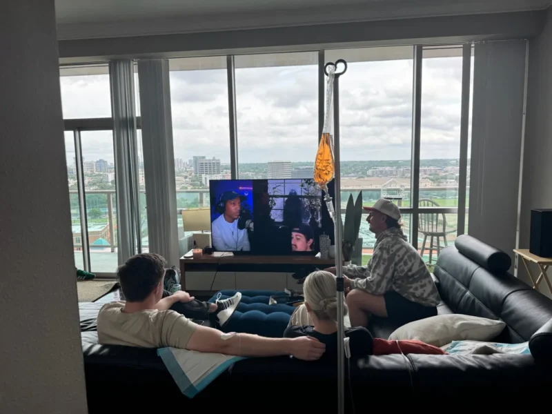 Group relaxing with IVs in a high-rise apartment living room